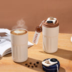Two Smart Insulated Coffee Cup with digital temperature displays on a wooden surface.