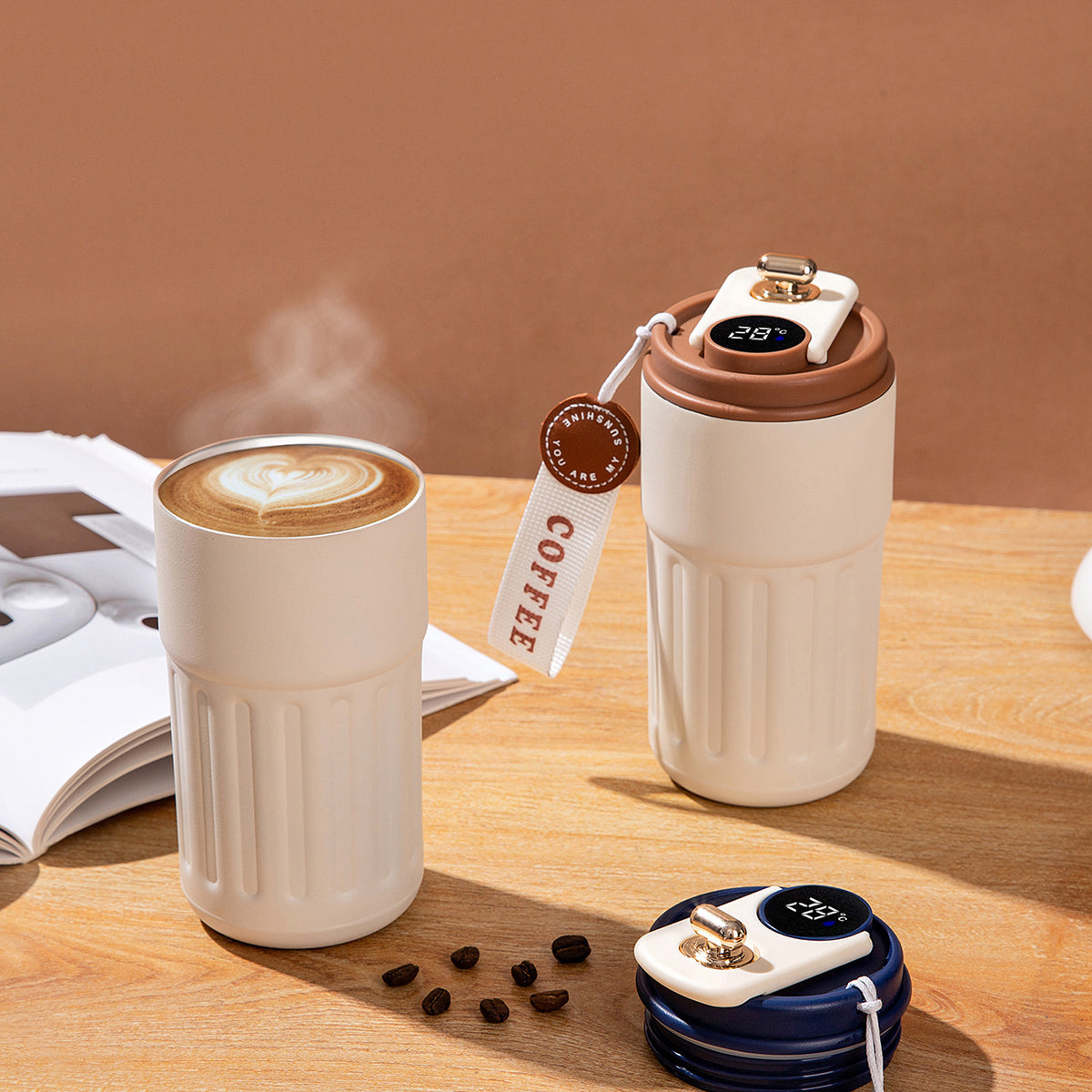 Two Smart Insulated Coffee Cup with digital temperature displays on a wooden surface.
