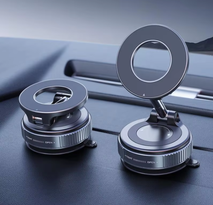 Two metallic car vacuum magnetic phone  holders with circular ring-shaped tops and suction-style bases, shown resting on a dark car dashboard.